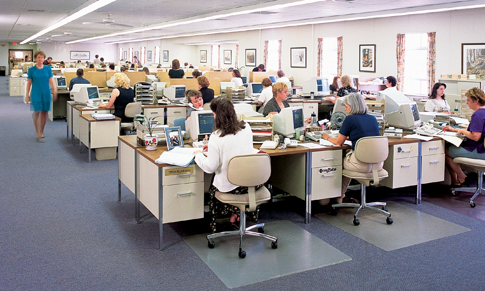 Group of employees in the NYCM Insurance building at their workstations in 2001.